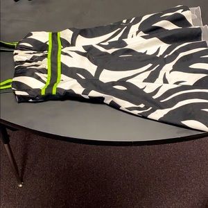 A white and black dress with lime green straps